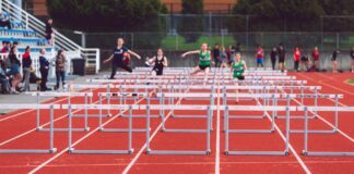 shallow focus photo of people playing track and field